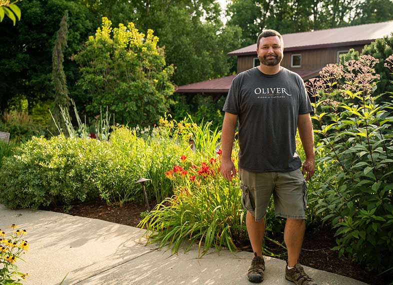 Horticulturist Dustin Stillinger stands among his handiwork in the winery gardens. 