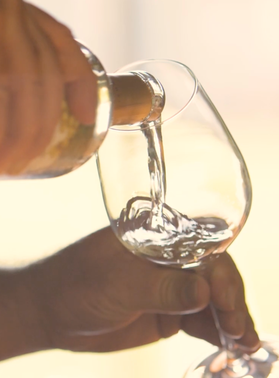 Soft White Wine Pouring into a glass for tasting