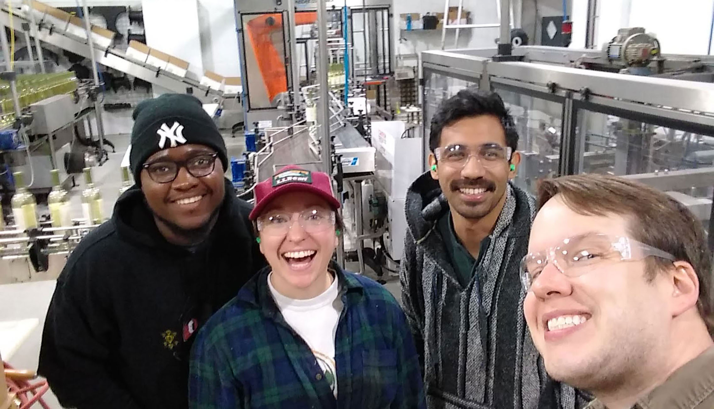 Oliver Winery staff members, enjoying working together on the bottling line. 