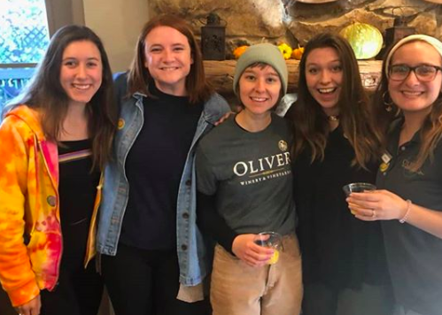A group of Oliver Winery staff members pose with smiles for a picture