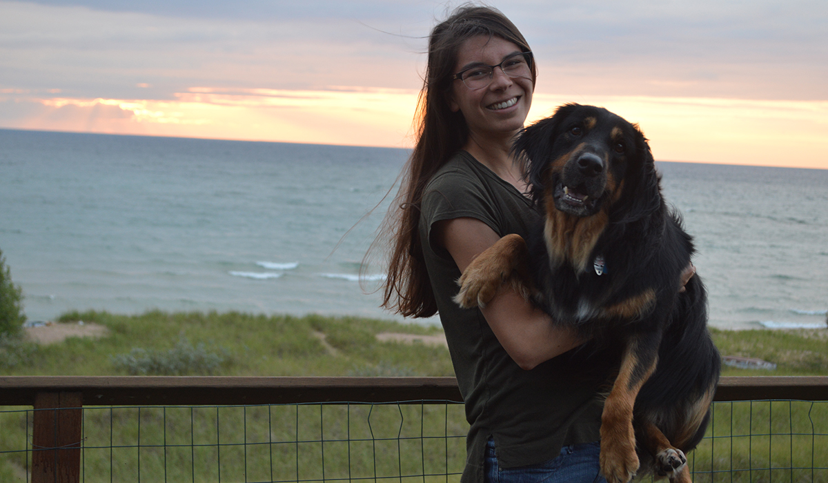 Allison posing with one of her pups.