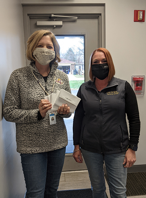 Our very own Carly delivering gift cards to Sheltering Wings.