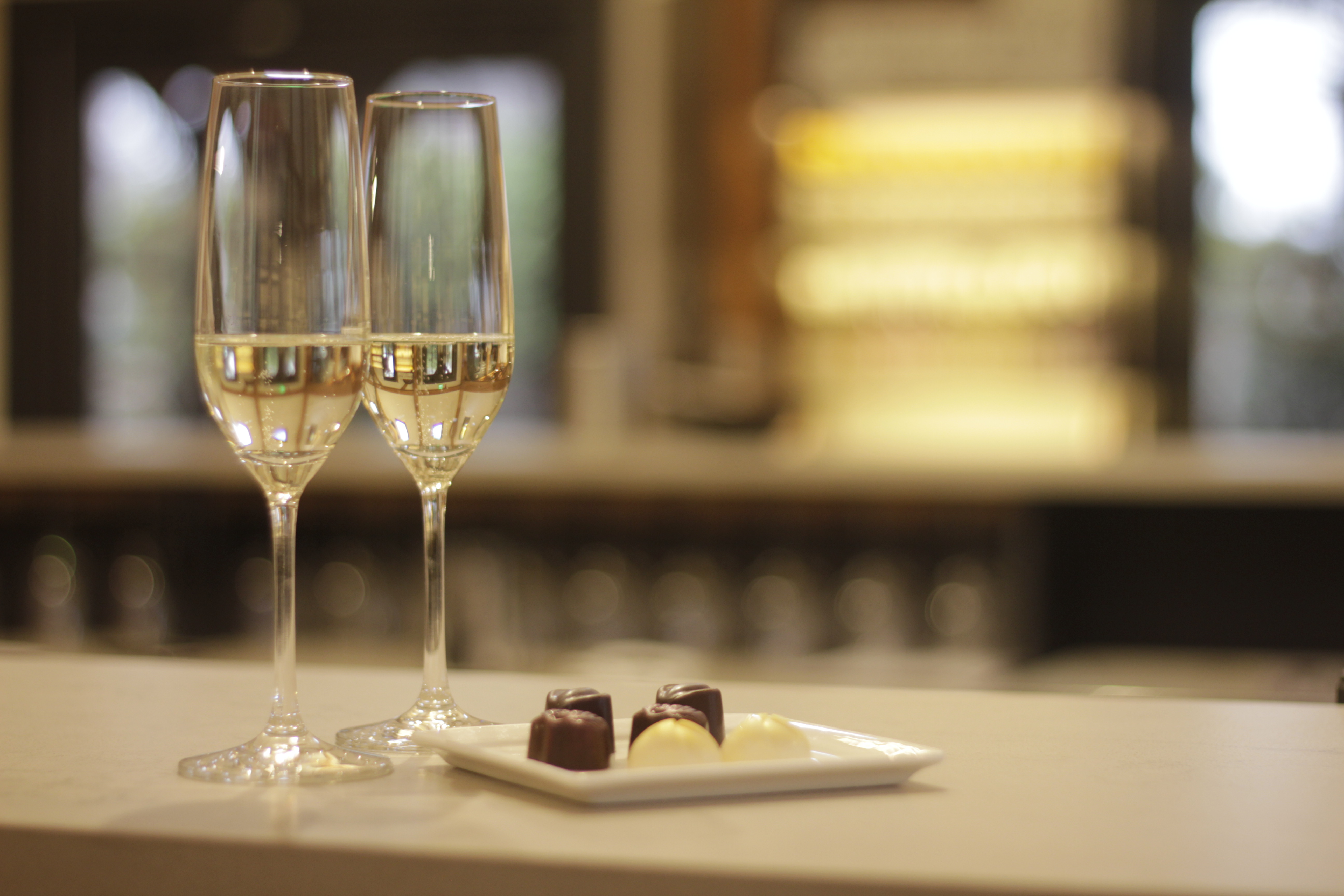 A glass of sparkling and locally made chocolate truffles at Oliver Winery. 
