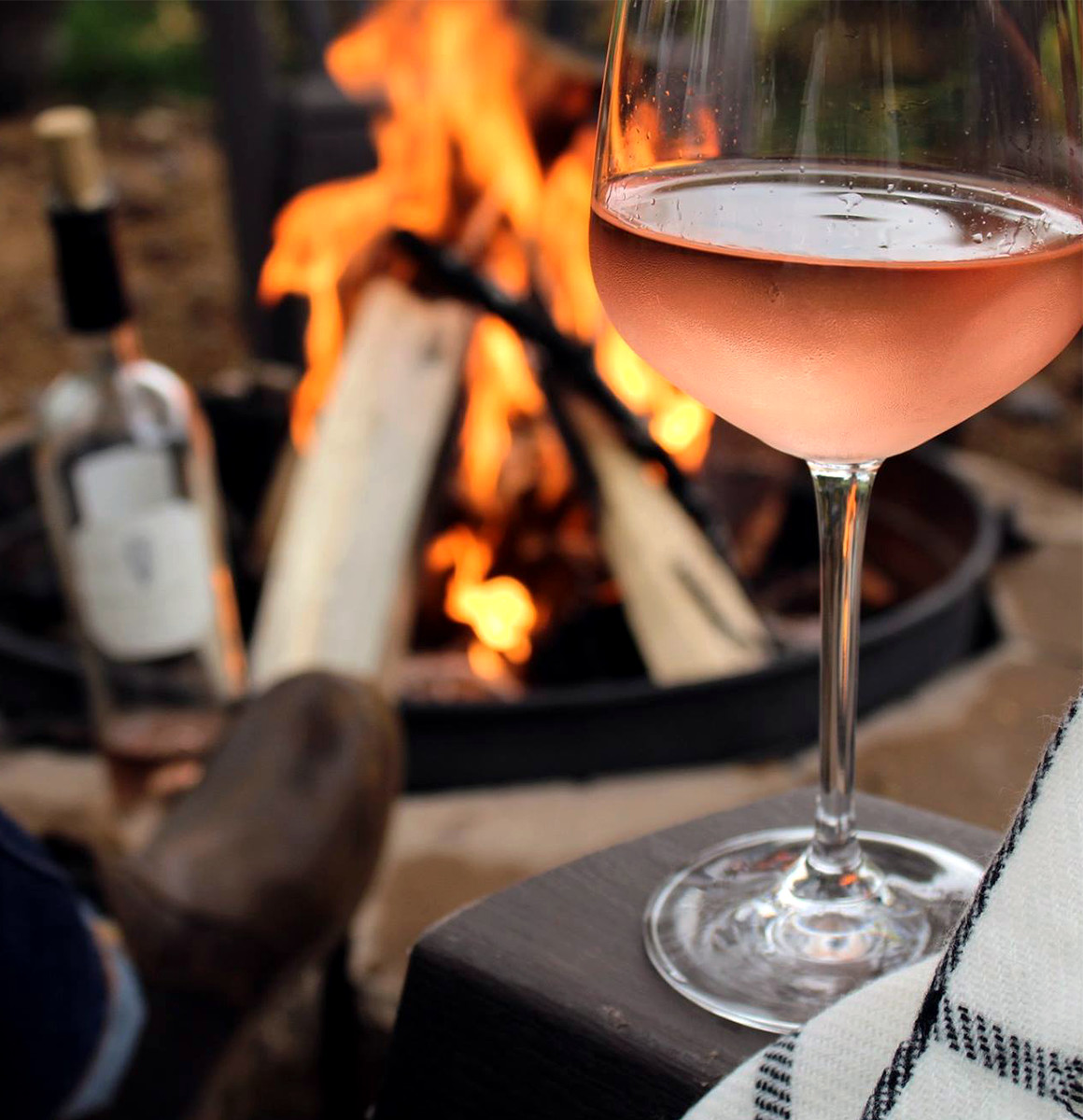 Catawba sweet rosé in a glass by a fire pit