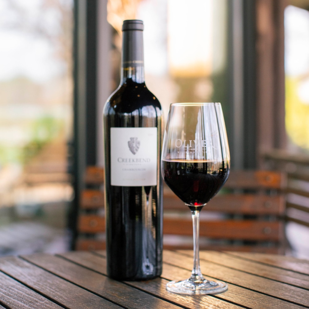 Creekbend Chambourcin on patio table in glass at Oliver Winery
