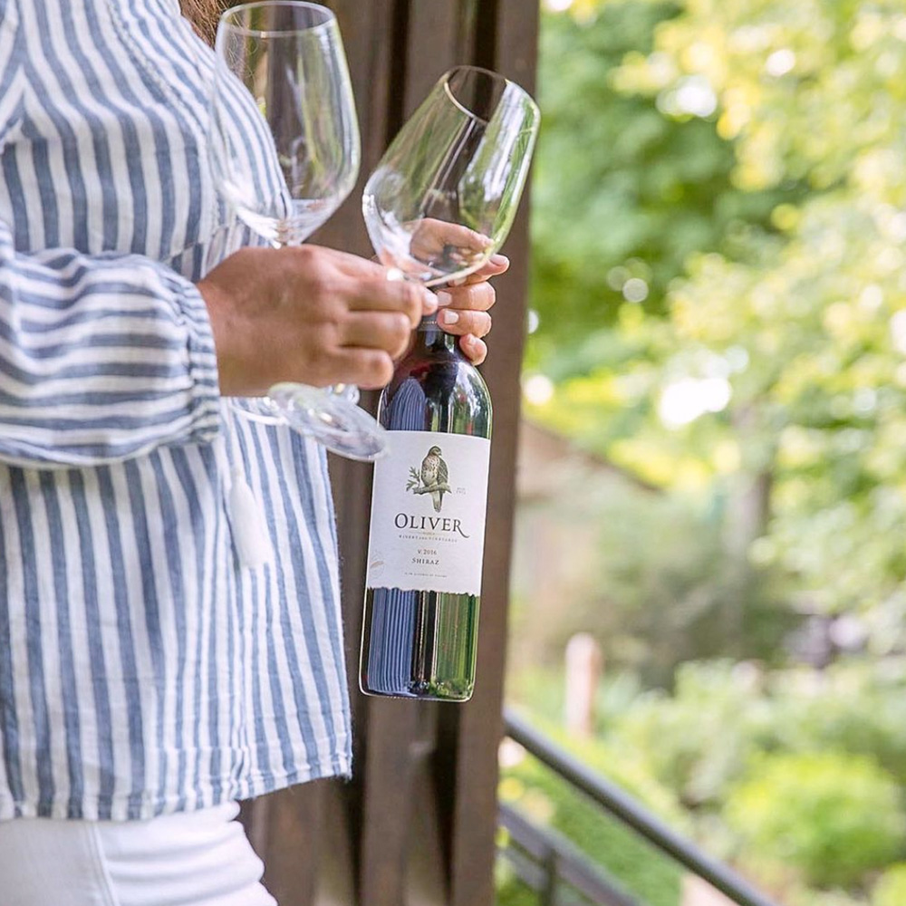 Shiraz in hand with two glasses