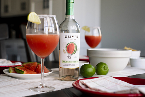 Oliver Winery's new Melon Mint Moscato in a Frosé cocktail, on table with melon and tacos