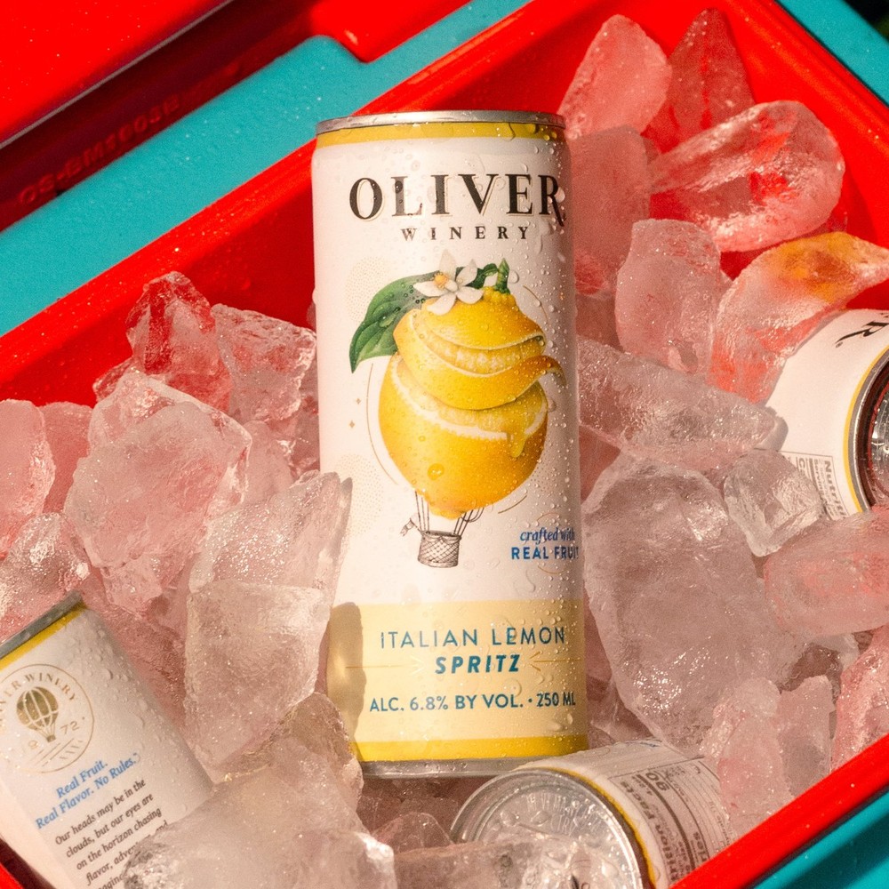 Oliver Winery Italian Lemon Spritz can standing in a cooler full of ice, with more cans tucked around it.